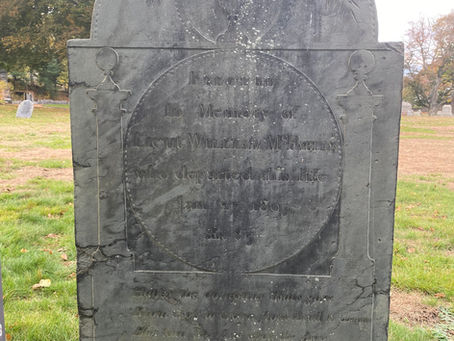 Slate gravestone with an urn and willow motif at the top