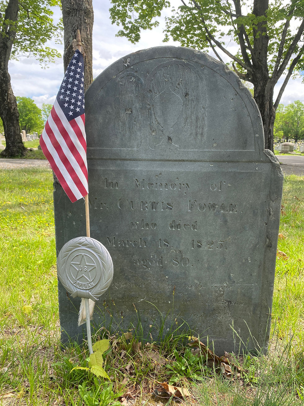 Slate gravestone with an urn and willow at the top and marked with a US flag