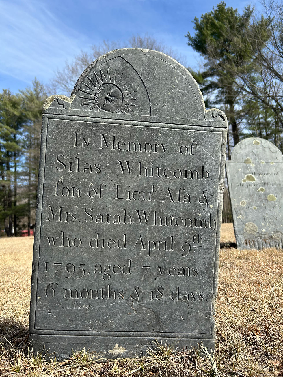 A setting sun is engraved on the top portion of Silas Whitcomb's gravestone