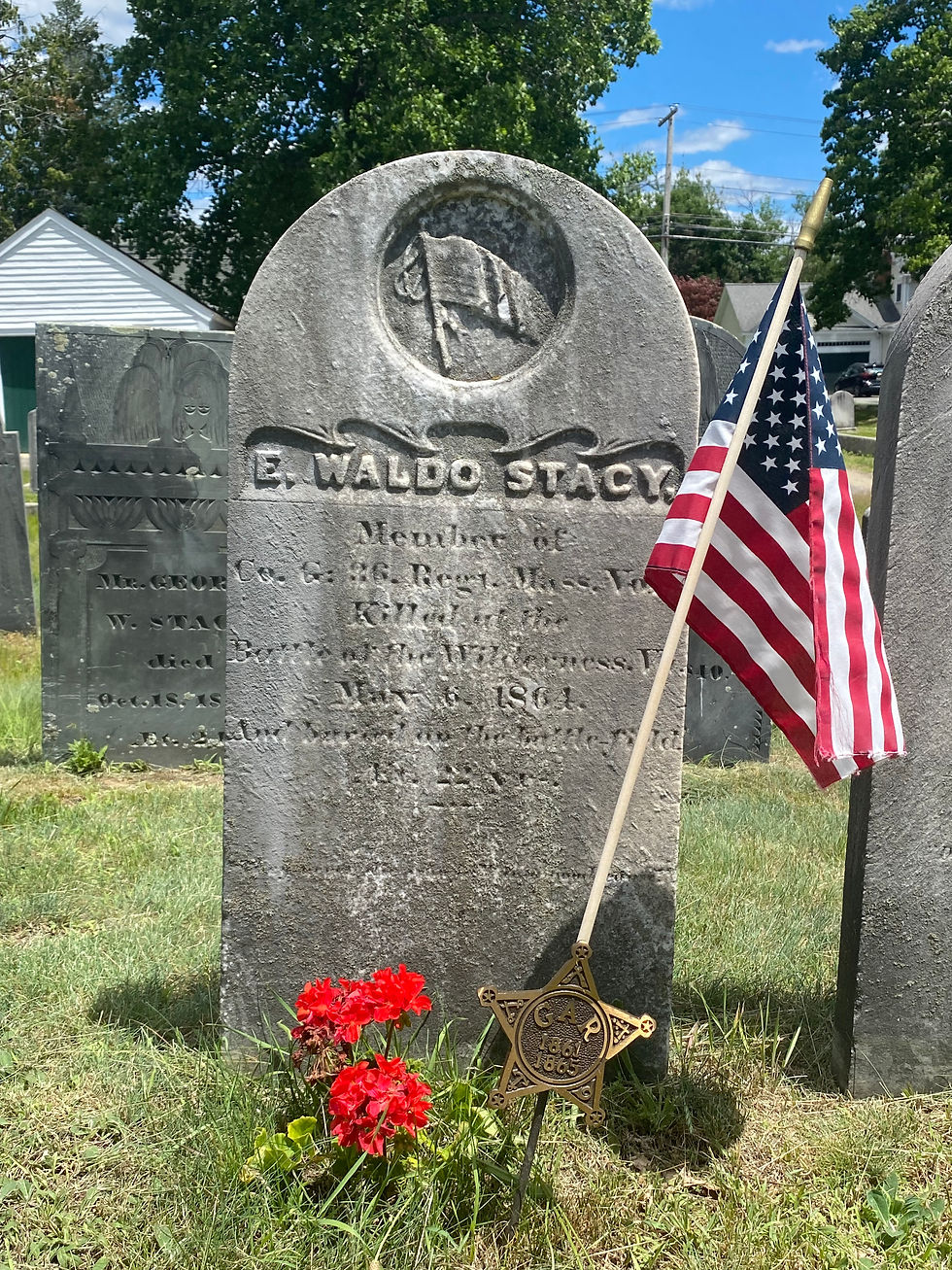Marble gravestone of E. Waldo Stacy with a US flag inscribed at the top