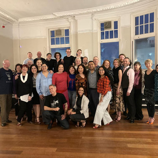 A group photo of tango dancers and students