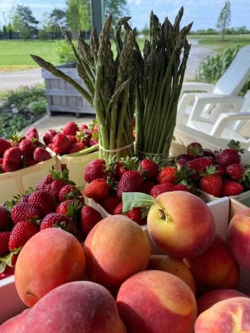 peaches, strawberries, and asparagus in containers