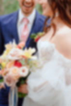 Bride and Groom holding colorful floral bouquet