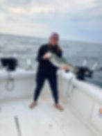 lake ontario fishing charters woman holding fish by mouth