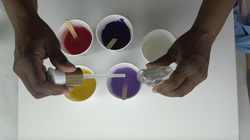 Artist is adding a liquid to paint.