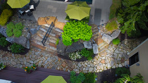 Stone walkways, stairs and shrub arranged in a landscape garden.