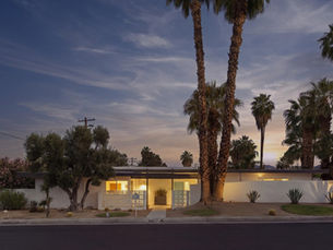 Front exterior view of 45930 Panorama Drive, a mid-century modern residence for sale on a corner lot in South Palm Desert, CA 92260, featuring clean architectural lines, desert landscaping, and a backdrop of the San Jacinto Mountains.