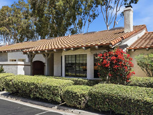 Front exterior view of 31472 Via La Senda, a reimagined single-level Spanish-style home for sale in the gated Capistrano De Oro community of San Juan Capistrano, CA 92675, featuring refined architectural details, a direct-access two-car garage, and a corner-unit orientation bathed in natural light.