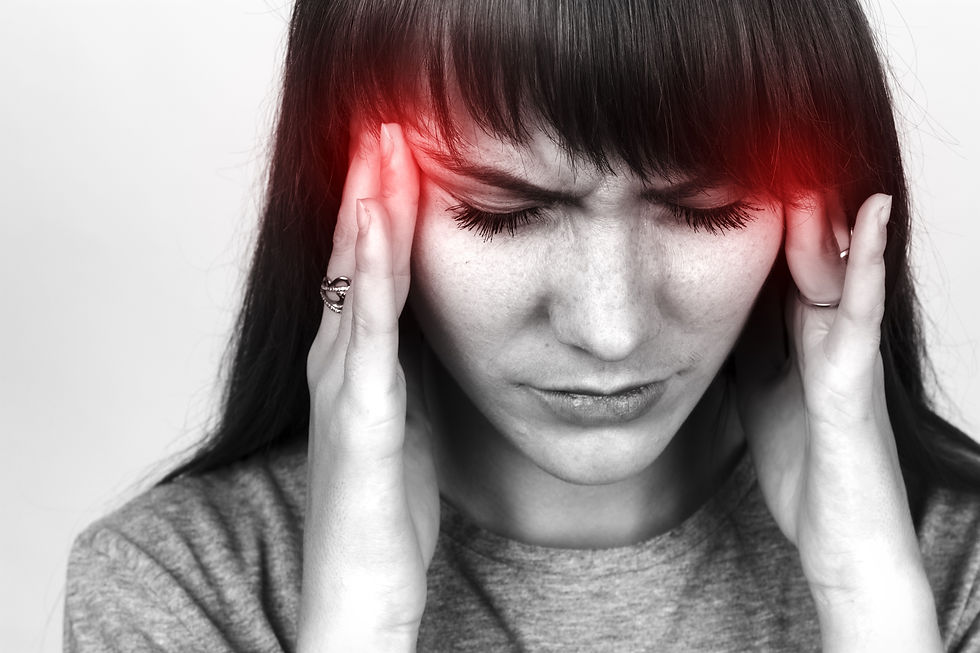 A close-up of a person gently massaging their temples in a serene home environment, evoking relief from tension.