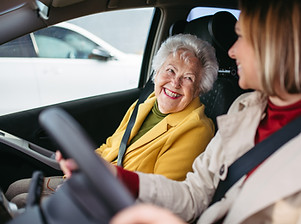 An elderly lady and female companion driving to an outing