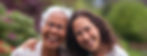 A female client smiling while getting a hug from her companion.