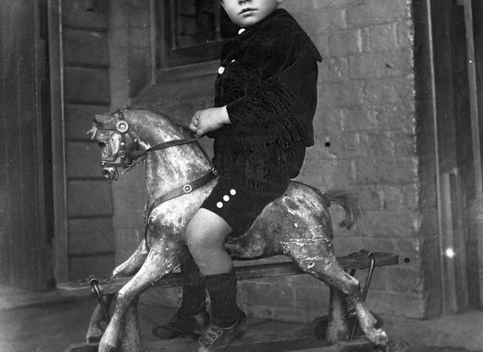 StateLibQld_2_167807_Young_boy_on_a_rocking_horse,_1900-1910.jpeg