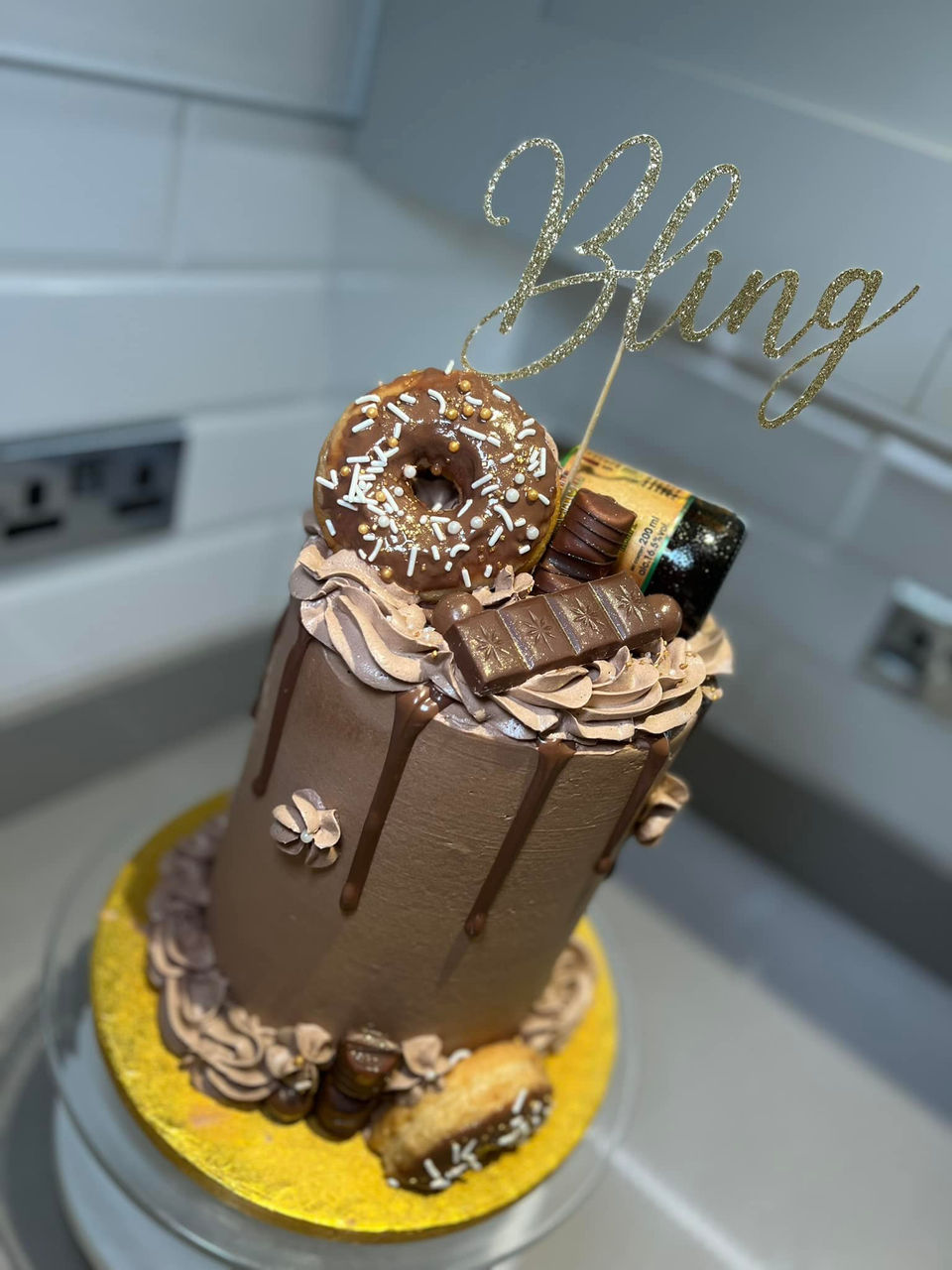 Chocolate drip cake with Bling topper, donuts, and chocolate bars