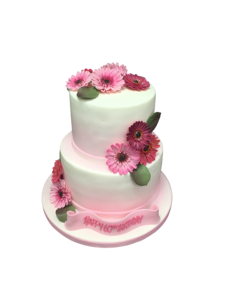 Bespoke celebration cake decorated with vibrant orange and yellow gerberas, crafted in Solihull, West Midlands.