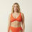 Miniaturbild: Oranges Bikinioberteil am Modell mit gedrehter Front