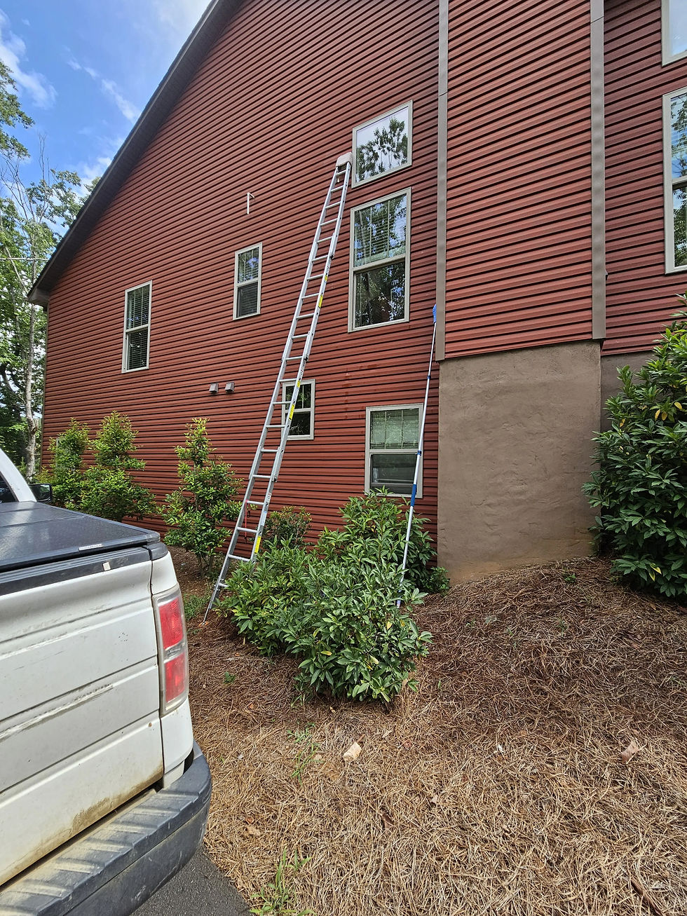 An aluminum ladder against a Peachtree Corners home ready to clean the storm windows