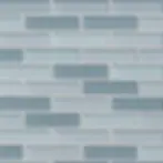 Close-up of rectangular glass mosaic tiles in shades of blue and gray with white grout