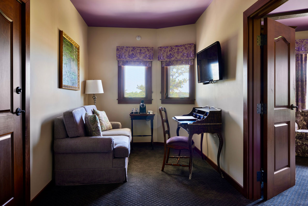lounge area with couch, desk, and flatscreen TV in junior suite at mirbeau