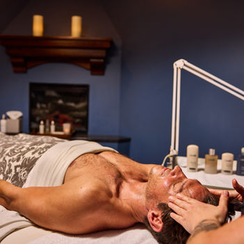 esthetician performing a men's facial 