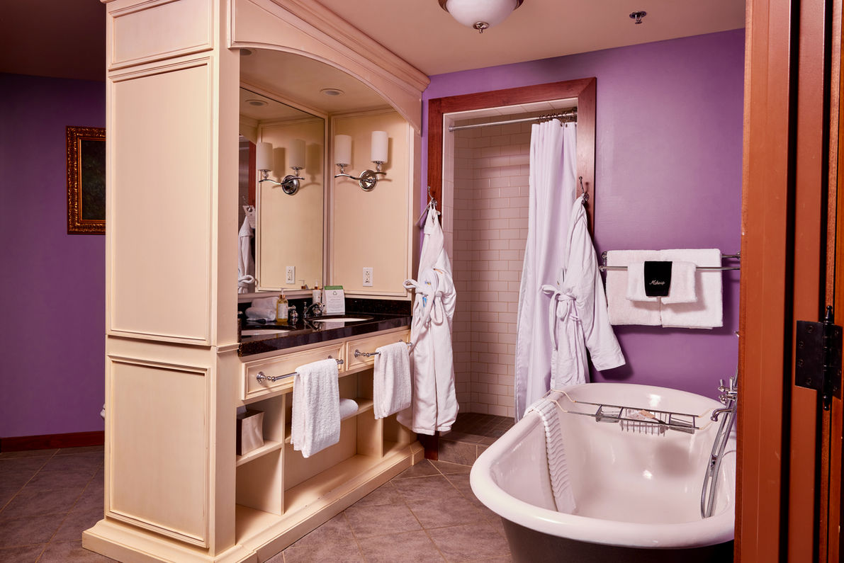 bathroom with spacious vanity, clawfoot bathtub, and walk-in shower