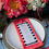 Thumbnail: Pink coral guava stripe tablescape table linen rental for wedding shower party event in Grand Rapids, Ann Arbor, Saugatuck