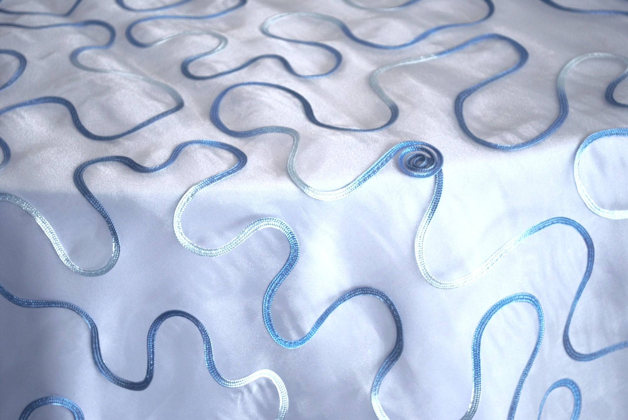 aquamarine blue white sheer mesh swirl squiggle overlay over table linen tablecloth rental michigan events party wedding