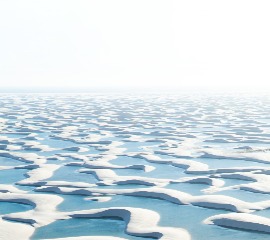 lunga distesa di sabbia bianca candida la cui superficie  calma con sottili onde che creano un effetto geometrico ripetitivo e una sensazione di tranquillità infinita.