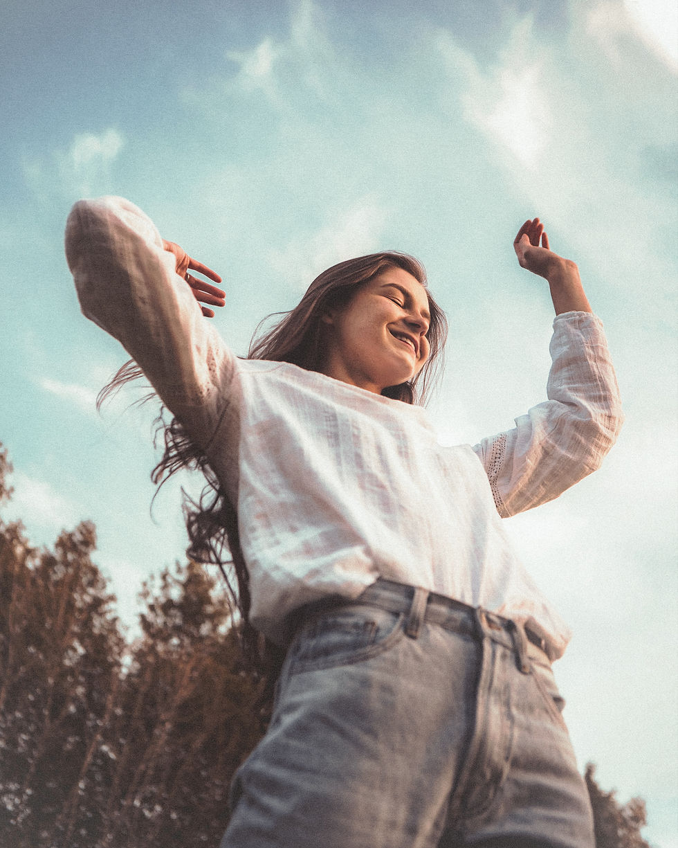 girl with white long sleeve shirt and arms up
