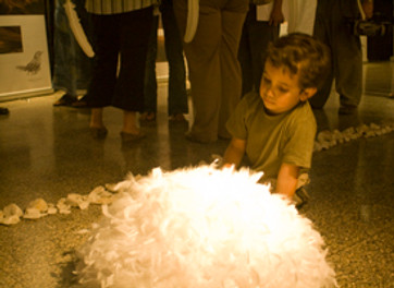 Boy playing with feathers