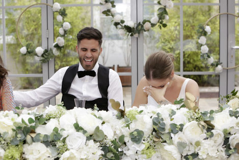 Bride and Groom laughing during their best man's wedding speech in the atrium of Botley's Mansion