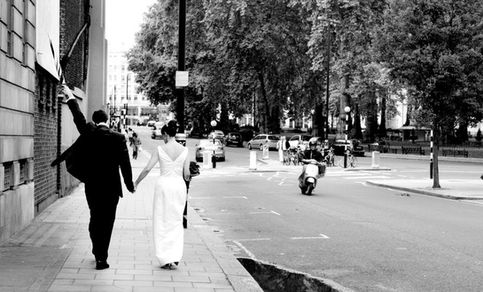 Bride and Groom walking along the streets of Berkeley Square after their wedding in Mayfair, London.