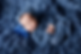 Sleeping Newborn boy on blue rug