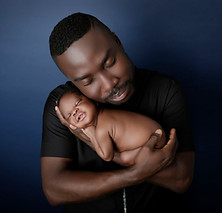 smiling newborn with father