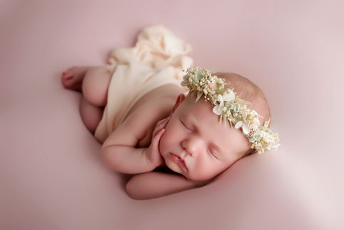 newborn girl wearing a flower crown - photographed at home in surrey
