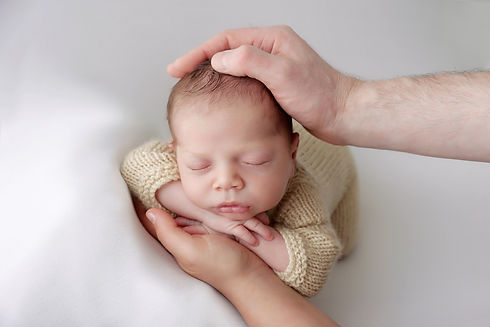 newborn-in-his-parents-hands.jpg