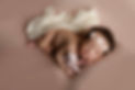 newborn girl with tiny pink teddy