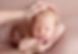 newborn being held by parents