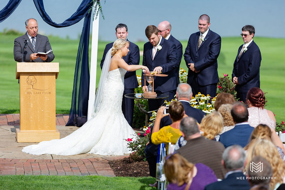 Bride and groom pouring sand into a hourglass