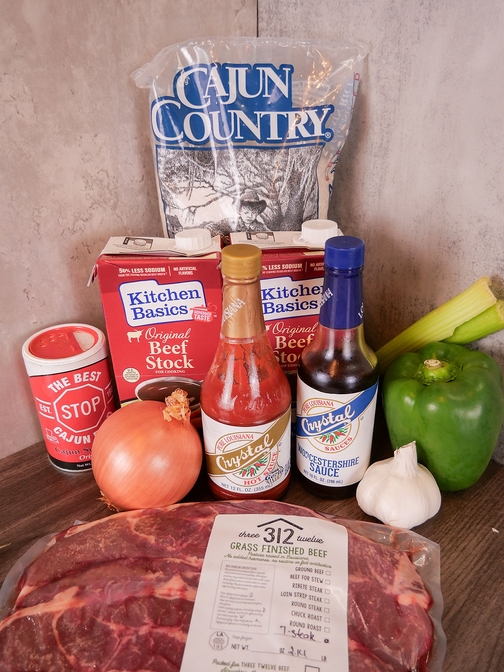 ingredients used in the recipe, including rice, beef stock, Cajun seasoning, an onion, a bell pepper, garlic, celery, hot sauce, Worcestershire sauce and beef steaks