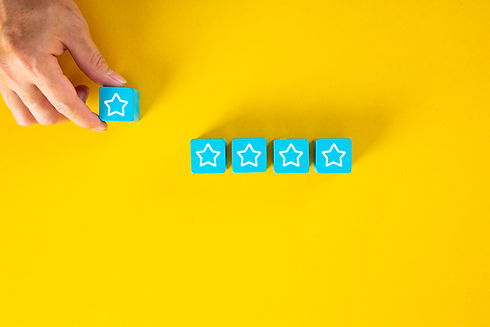 male-hand-placing-wooden-cubes-with-five-star-rating-yellow-background.jpg