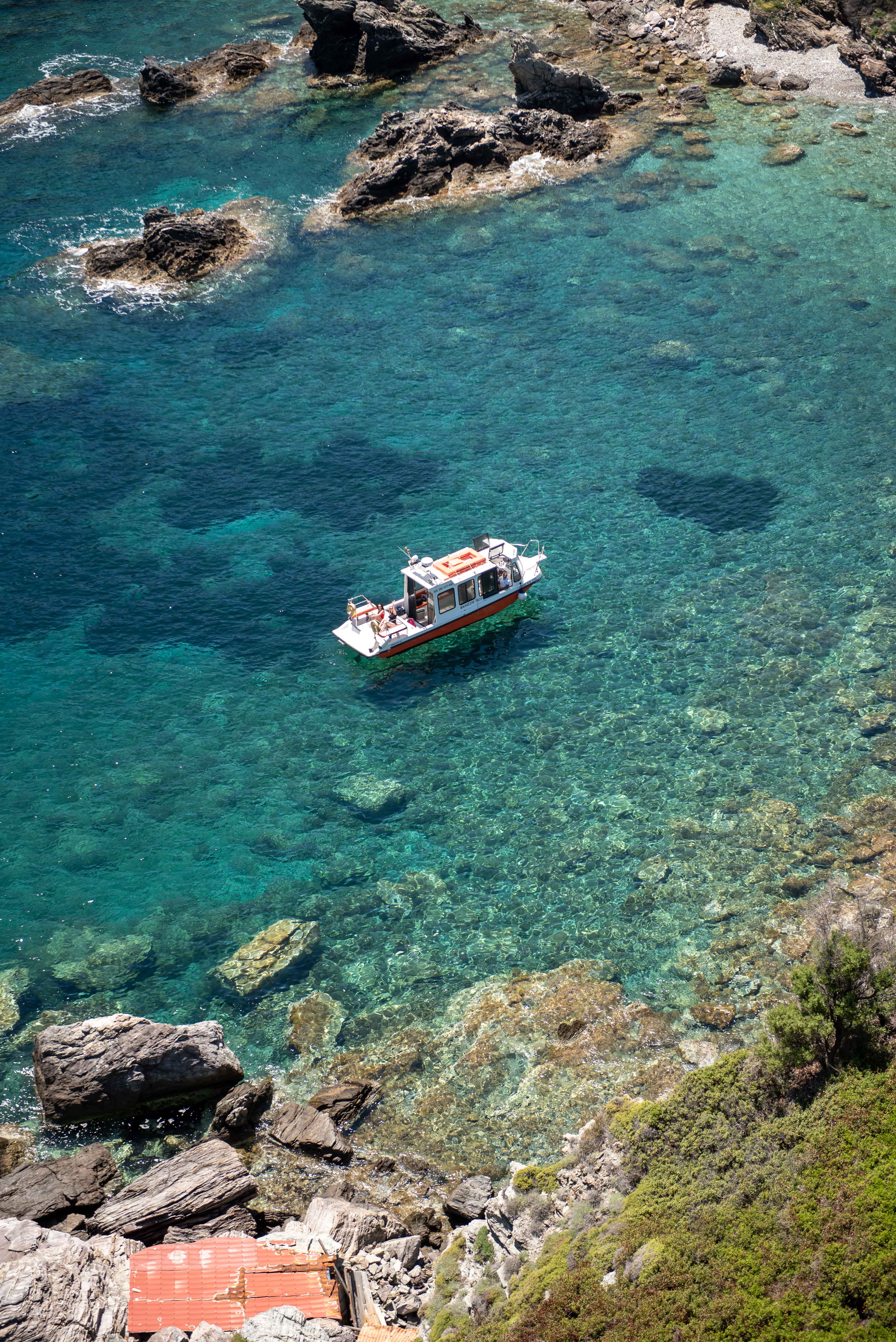 Calm crystal blue water gently touching weathered white marble steps.