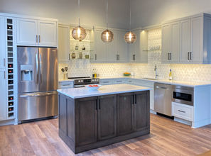 Downtown Minneapolis Loft Kitchen
Stained rolling white oak island, Karndean Mid Limed Oak luxury vinyl flooring, exposed brick  wall, Sherwin Williams Repose Gray, Cambria Swanbridge, matte black cabinet pulls, glass shelves, LED tape lighting, Besa Wave 10 pendants Smoke. Kohler Vault K3839-1-NA sink,  American Standard 
Edgewater Kitchen Faucet 7077131, wine cubbies, side by side stainless steel refrigerator 