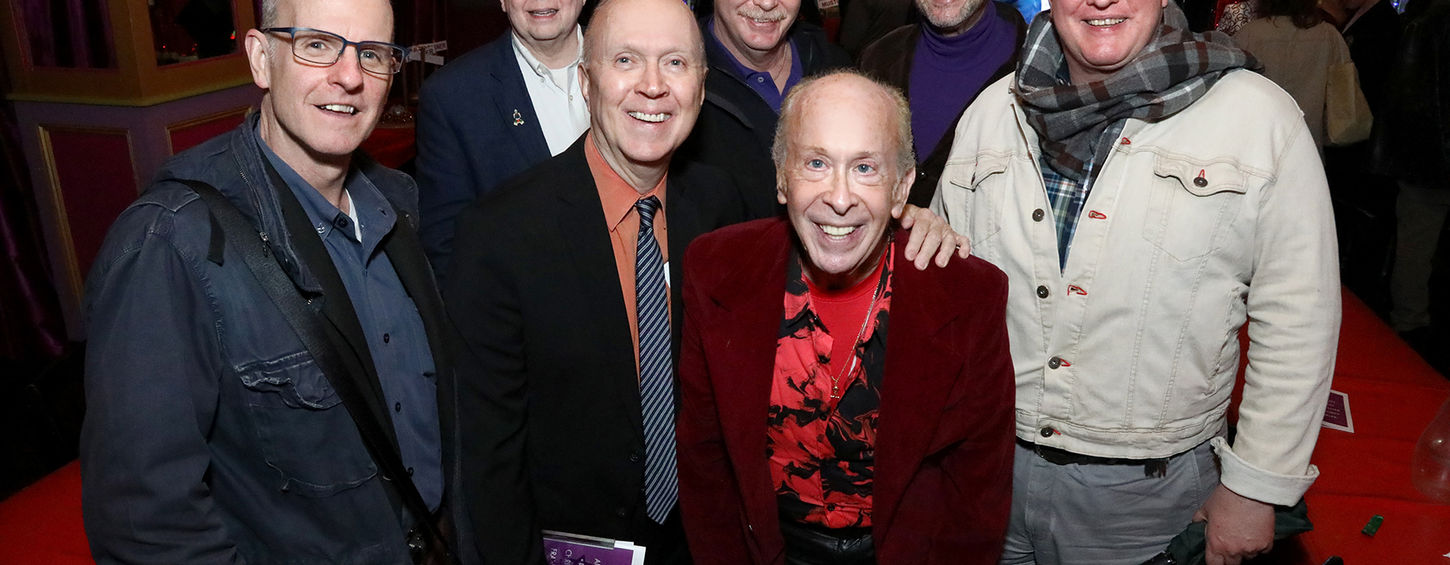 Group of men smiling at a