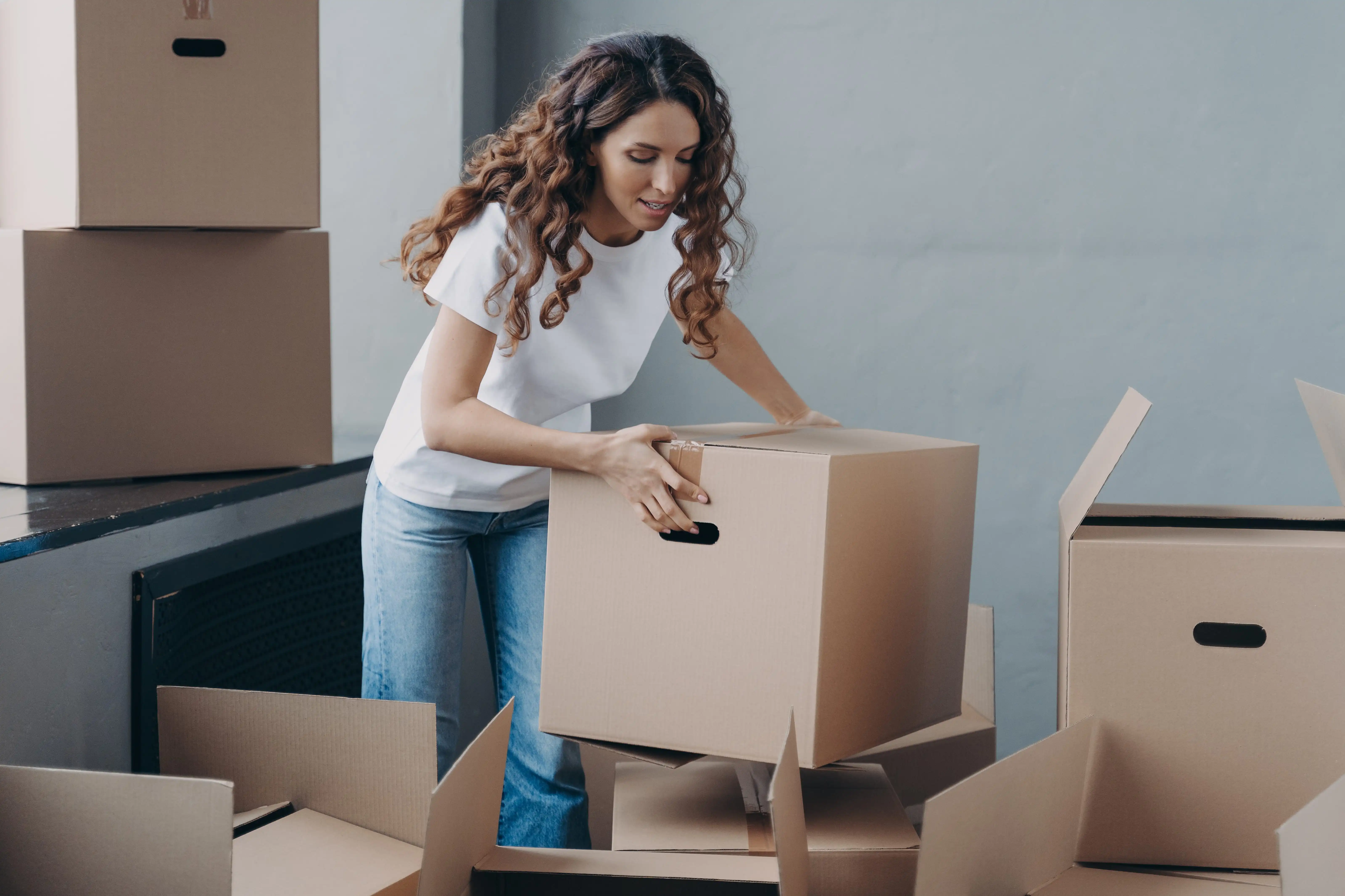 woman moving large packing boxes