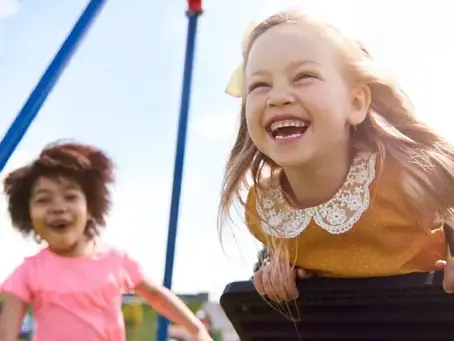 Two children playing outdoors, reflecting the family focus of Afton Pediatric Dentistry in Concord NC