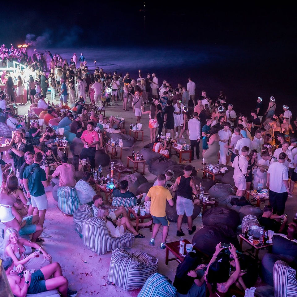 The beach edge at Love Beach Club on New Year's Eve 2025, where the VIP Seaview tables face the sea and the fireworks