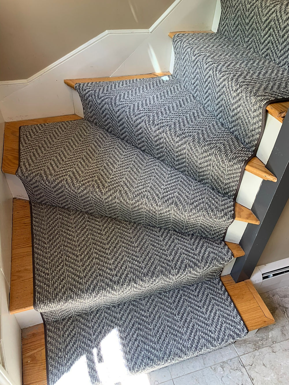 Patterned carpet runner on curved staircase