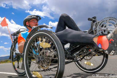 An adaptive rider peddles his way across Hwy 120.
