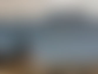 A girl stares off to the distant silhouetted jagged mountain of the Sierra Nevadas including the Minarets, Ritter, and Banner.