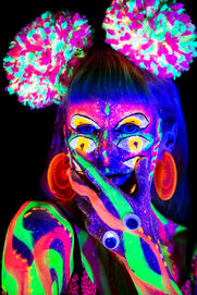 Neon body paint with glowing accessories in UV light with lots of eyes.